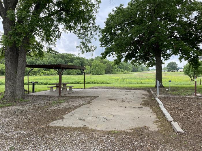 A photo of Site 20 of Loop A at Damsite Texas with Picnic Table, Electricity Hookup, Sewer Hookup, Fire Pit, Shade, Water Hookup