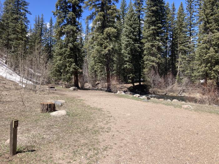 A photo of Site 12 of Loop F at WILLIAMS CREEK CAMPGROUND with Picnic Table, Fire Pit, Waterfront
