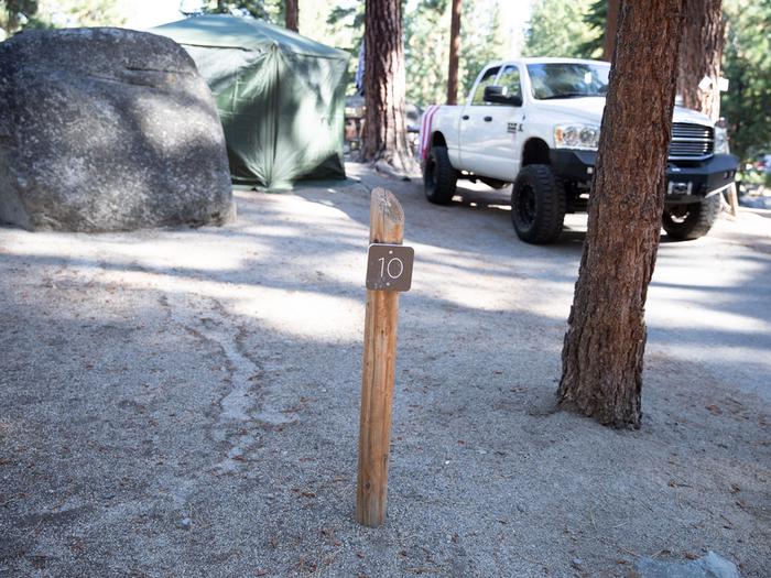 Campsite #10 tree shaded area, picnic table, and parking area.Campsite #10