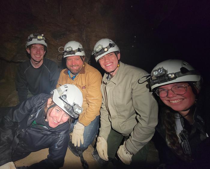 Five smiling visitors enjoying the inside of Hansen Cave"That was awesome!" Happy visitors on Introduction to Caving Tour