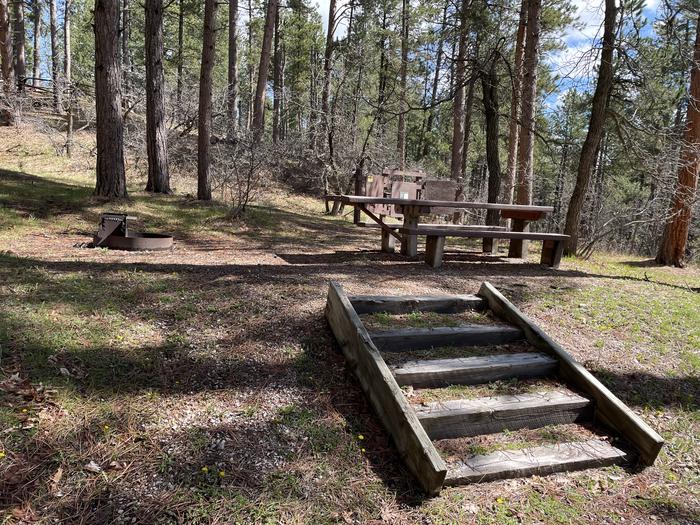 Table and Fire Ring in Site 30 with Cliff Swallow Trailhead in BackgroundPicnic Area in Site 30