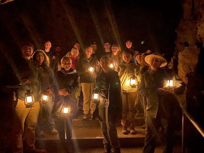 Ranger with a large group of happy visitors holding their lanternsHistoric lantern tours are the best!
