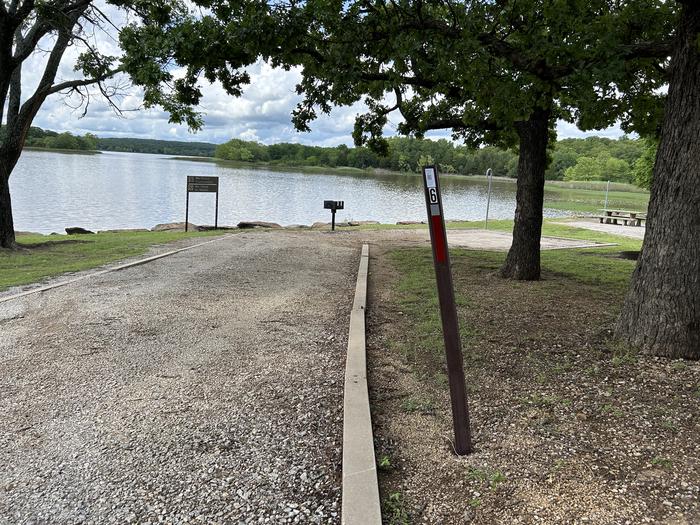 A photo of Site 6 of Loop  at Sunset Bay with Boat Ramp, Picnic Table, Fire Pit, Shade, Tent Pad, Waterfront, Lantern Pole