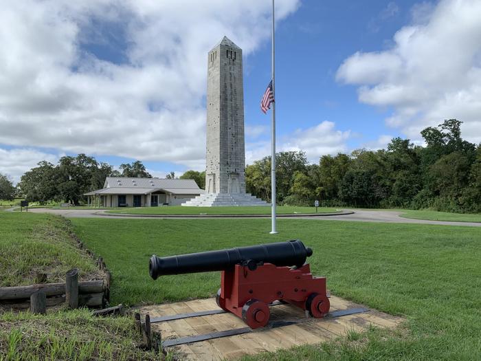 The American Rampart at ChalmetteAn American cannon sits at the rampart overlooking the battlefield. Behind it is the American flag, the Chalmette Monument, and the Visitor Center.