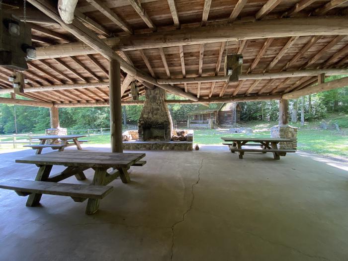 Under the PavilionPicnic tables and a fireplace are located underneath the pavilion.