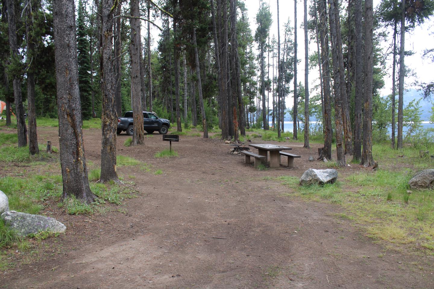 View of the campground in the trees. Deadwood reservoir is vilsible in the backView of campsite 4. 