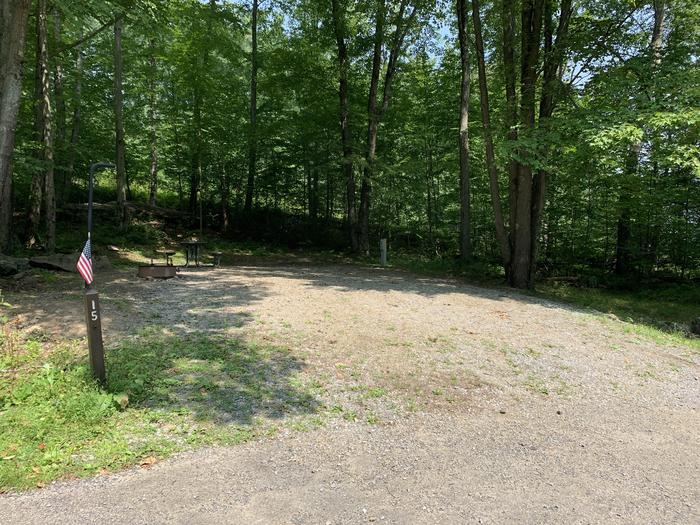 A photo of Site 15 of Loop East Branch at East Branch Campground with Picnic Table, Electricity Hookup, Fire Pit, Shade, Lantern Pole