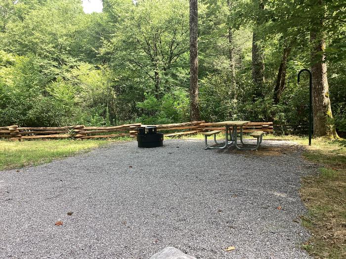 A photo of Site 006 of Loop River at BLACK MOUNTAIN CAMPGROUND with Picnic Table, Fire Pit, Shade, Tent Pad, Waterfront, Lantern Pole