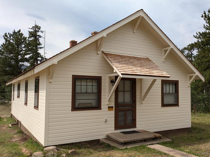 Cabin with lapped siding and cedar roof with pine trees in the backgroundBuckhorn Ranger Cabin (AKA Fullen Kamp Cabin).