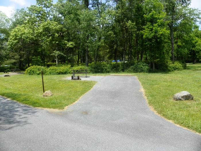 Campsite A75 has back-in driveway, picnic table, fire ring, and tent pad. 