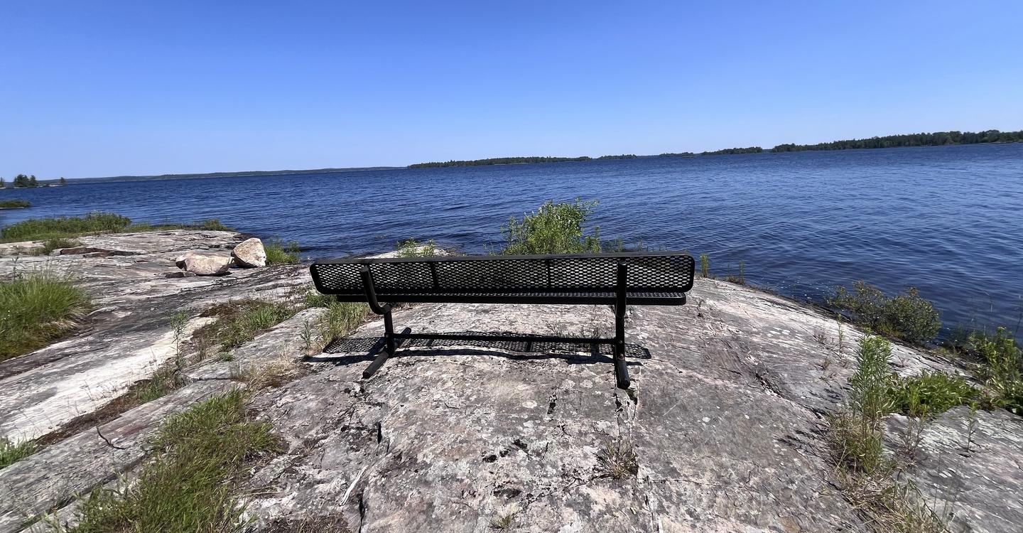R74 - Rainy Lake Group, bench on rock point overlooking the water.Bench overlook