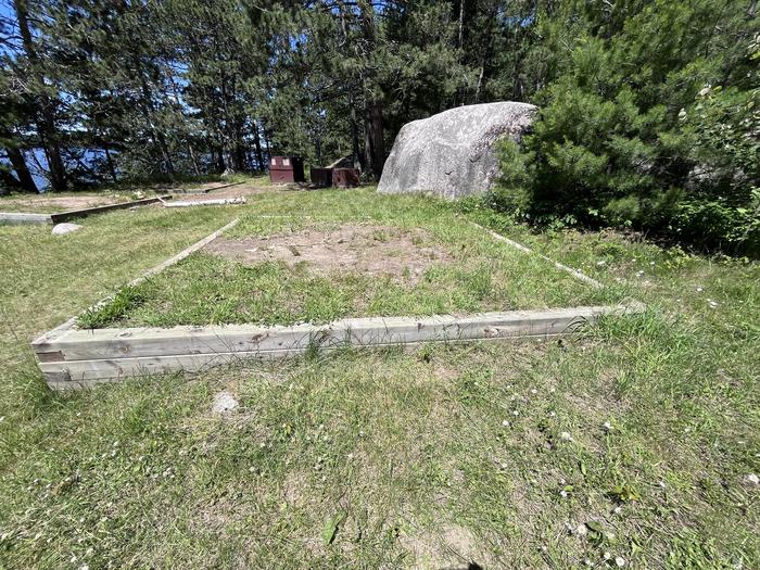 Mukooda Lake Bass Campsite, tent pad #2 with a couple of bear lockers and tent pads in the backgroundTent Pad #2