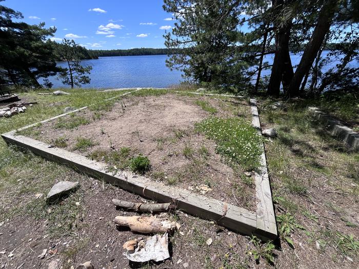 Mukooda Lake Bass Campsite, tent pad #3 at campsite with water in the backgroundTent Pad #3