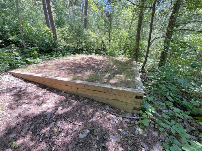 Mukooda Lake Crappie campsite, tent pad #1 with greenery in the backgroundTent Pad #1