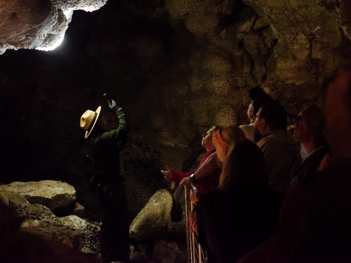 A park ranger highlighting a portion of cave passage.Visitors learn about the geologic and human history of Jewel Cave on our Cave Tours.