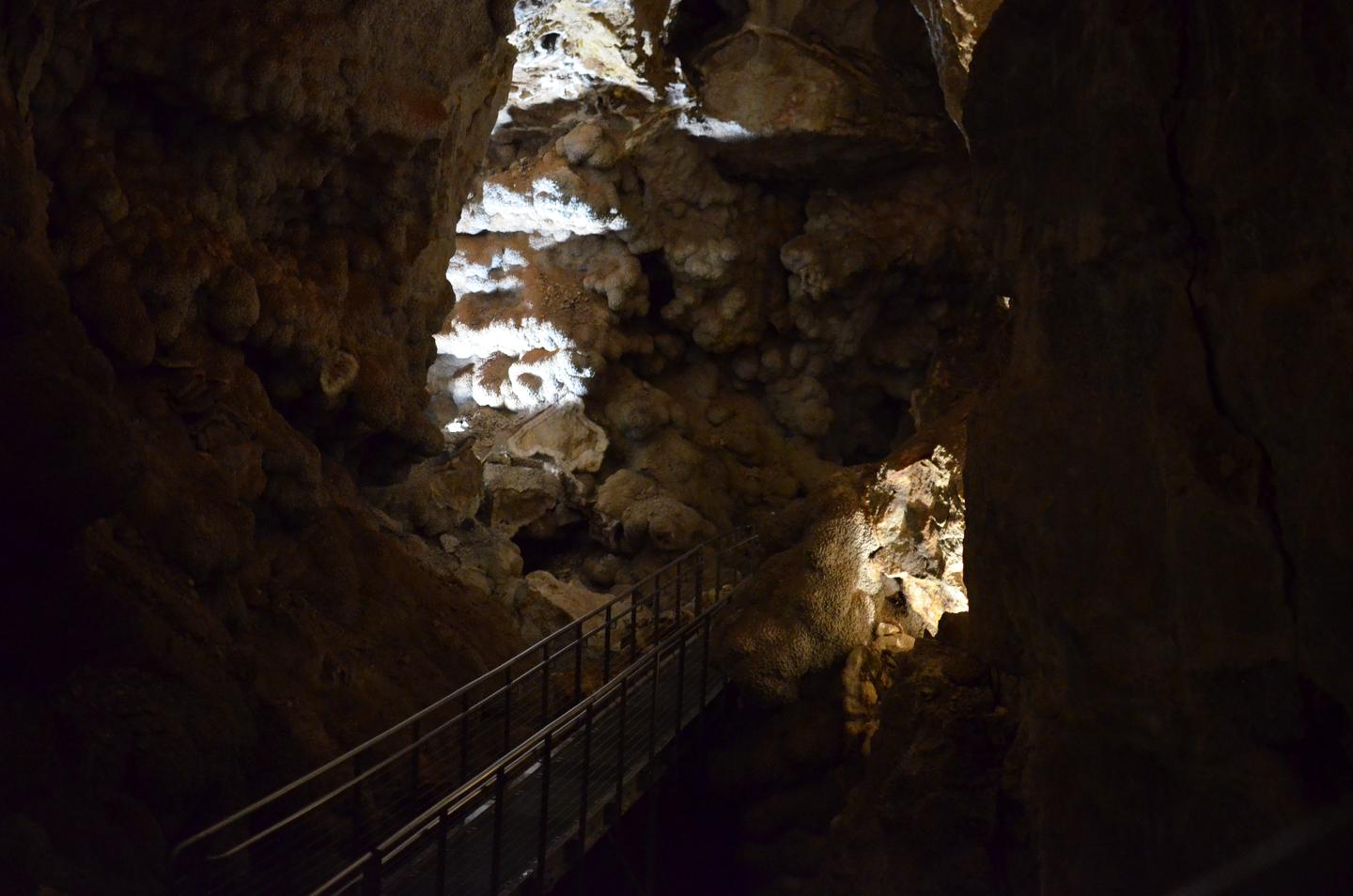 A large cave room with an elevated pathwayCalcite crystal completely coats Jewel Cave where breakdown did not occur.