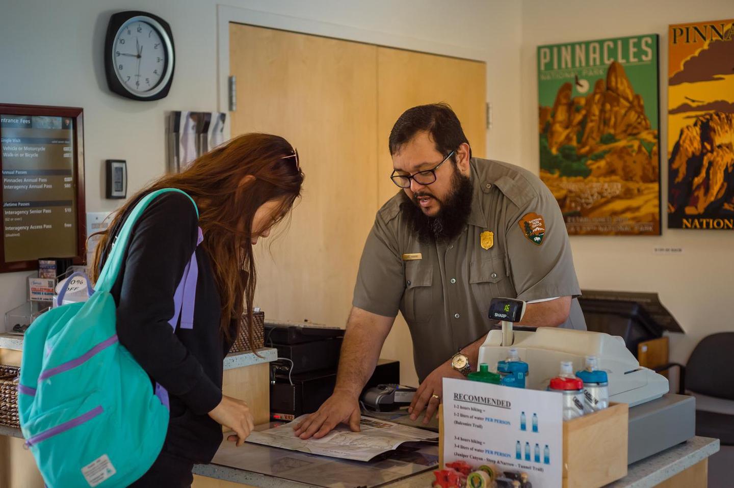 Inside the West Visitor Contact StationA park ranger helping a park visitor