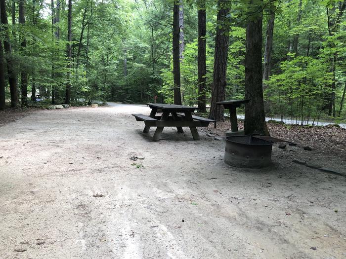 A photo of Site 030 of Loop B at CAVE MOUNTAIN LAKE FAMILY CAMP with Picnic Table, Fire Pit, Shade, Tent Pad, Lantern Pole