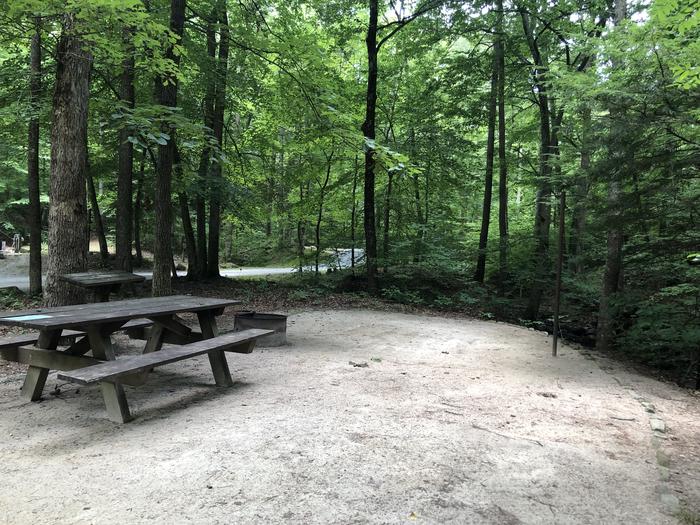 A photo of Site 030 of Loop B at CAVE MOUNTAIN LAKE FAMILY CAMP with Picnic Table, Fire Pit, Shade, Tent Pad, Lantern Pole