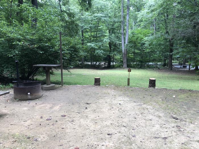 A photo of Site 038 of Loop B at CAVE MOUNTAIN LAKE FAMILY CAMP with Fire Pit, Shade, Tent Pad, Lantern Pole