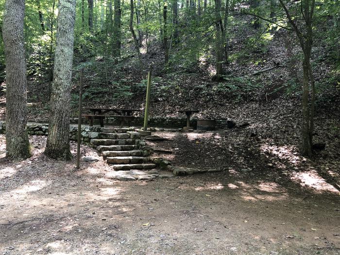 A photo of Site 013 of Loop CAVE MOUNTAIN LAKE FAMILY CAMP at CAVE MOUNTAIN LAKE FAMILY CAMP with Picnic Table, Fire Pit, Shade, Tent Pad, Lantern Pole