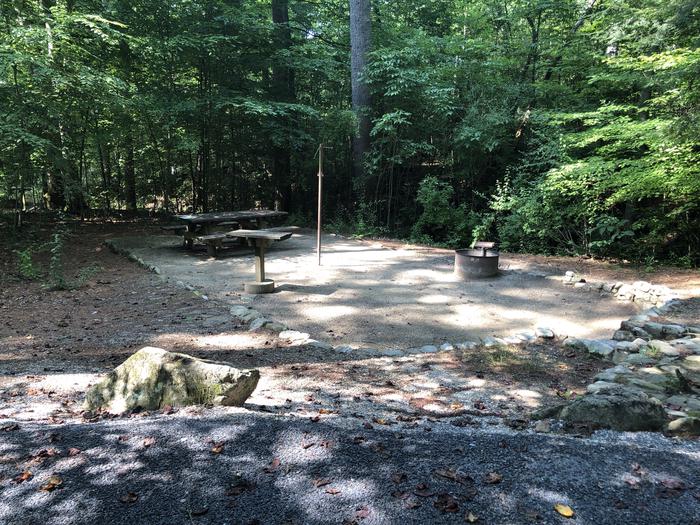 A photo of Site 032 of Loop B at CAVE MOUNTAIN LAKE FAMILY CAMP with Picnic Table, Fire Pit, Shade, Tent Pad, Lantern Pole