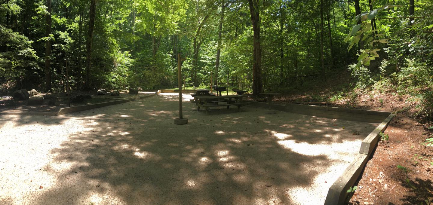 A photo of Site 041-042 of Loop CAVE MOUNTAIN LAKE FAMILY CAMP at CAVE MOUNTAIN LAKE FAMILY CAMP with Picnic Table, Fire Pit, Shade, Tent Pad, Lantern Pole