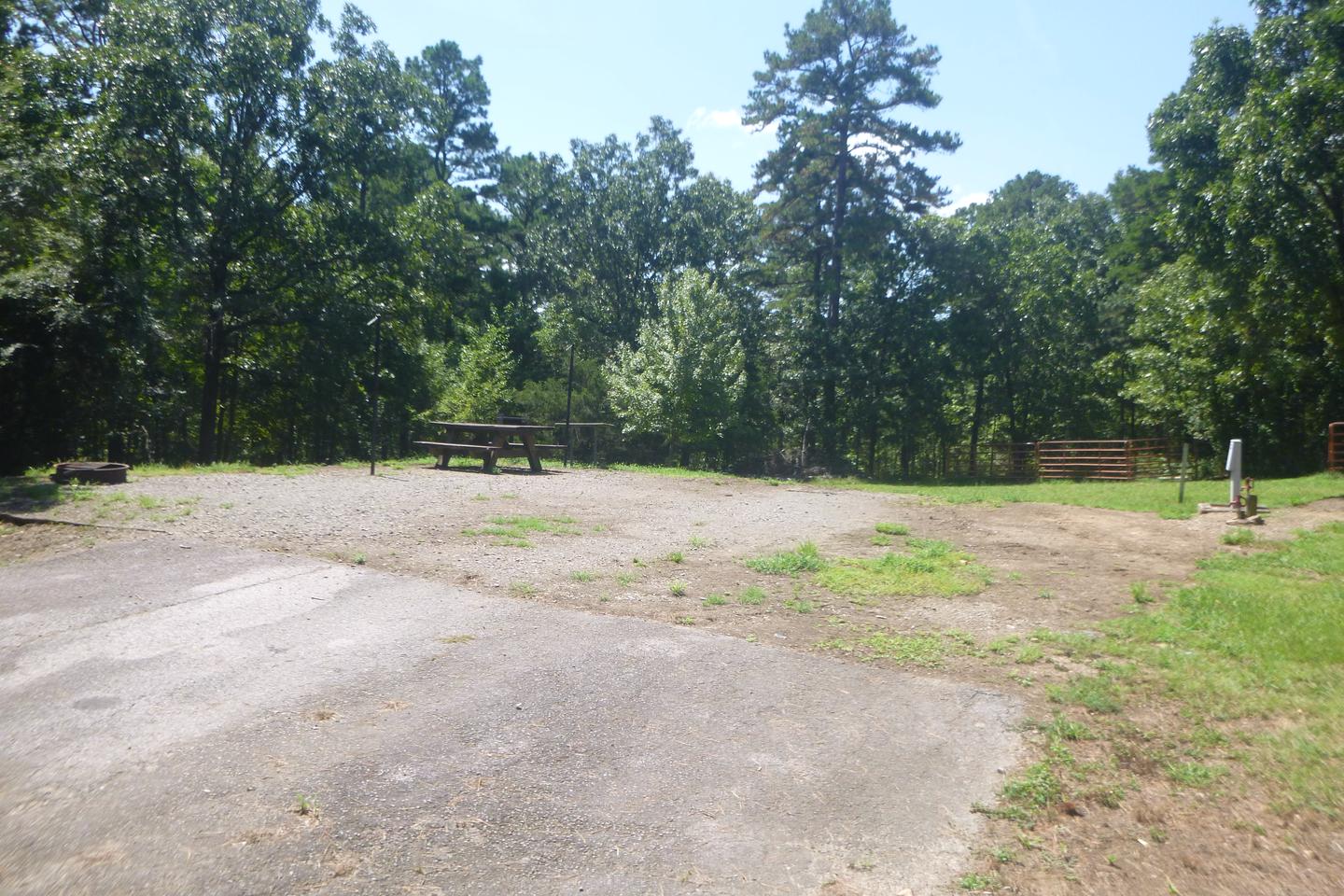 Site E8 with picnic tables, fire ring, lantern posts, horse pens, water hookup, electric hookupSite E8