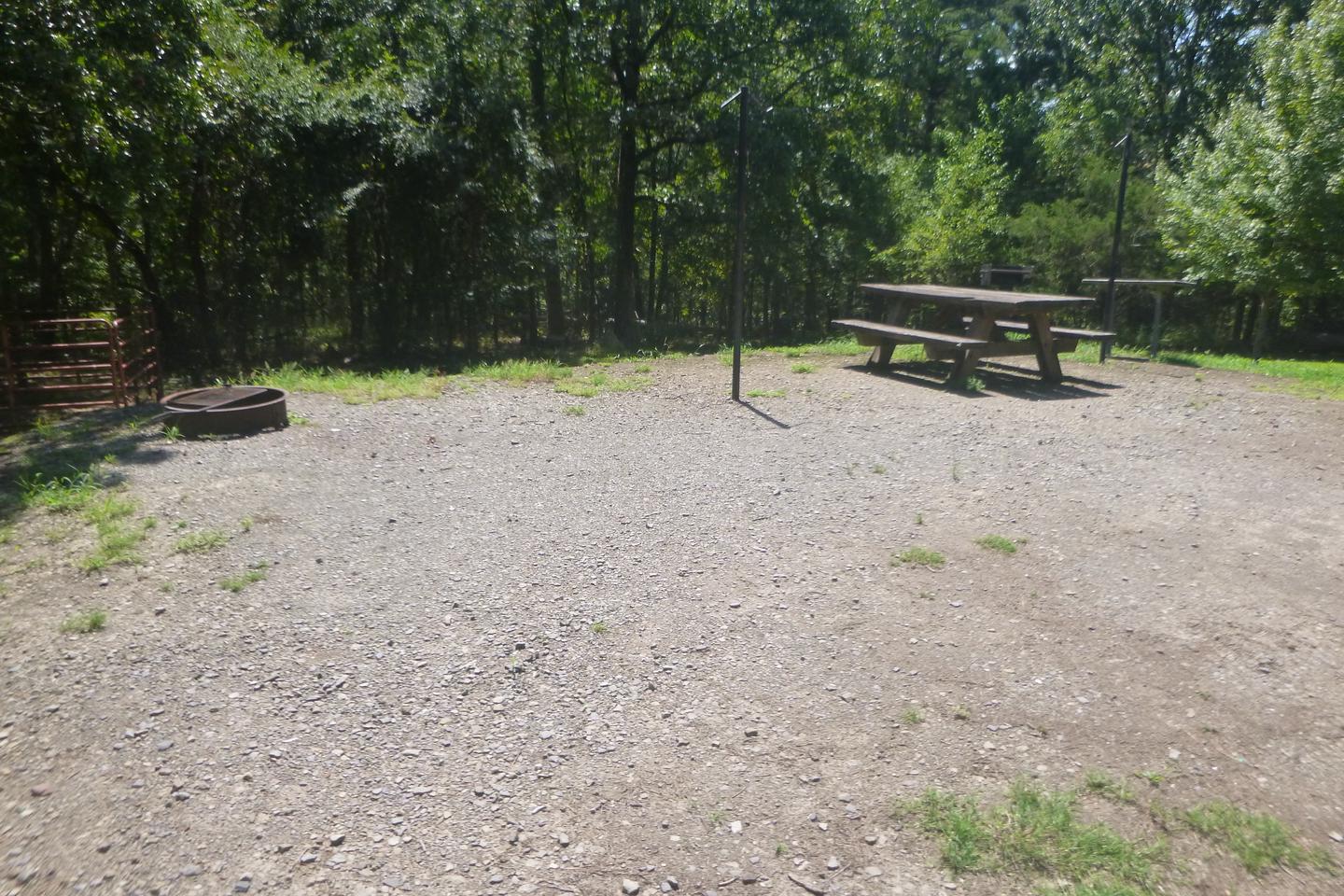 Site E8 with picnic table, fire ring, lantern posts, grillSite E8 wit picnic table, fire ring, lantern posts, grill