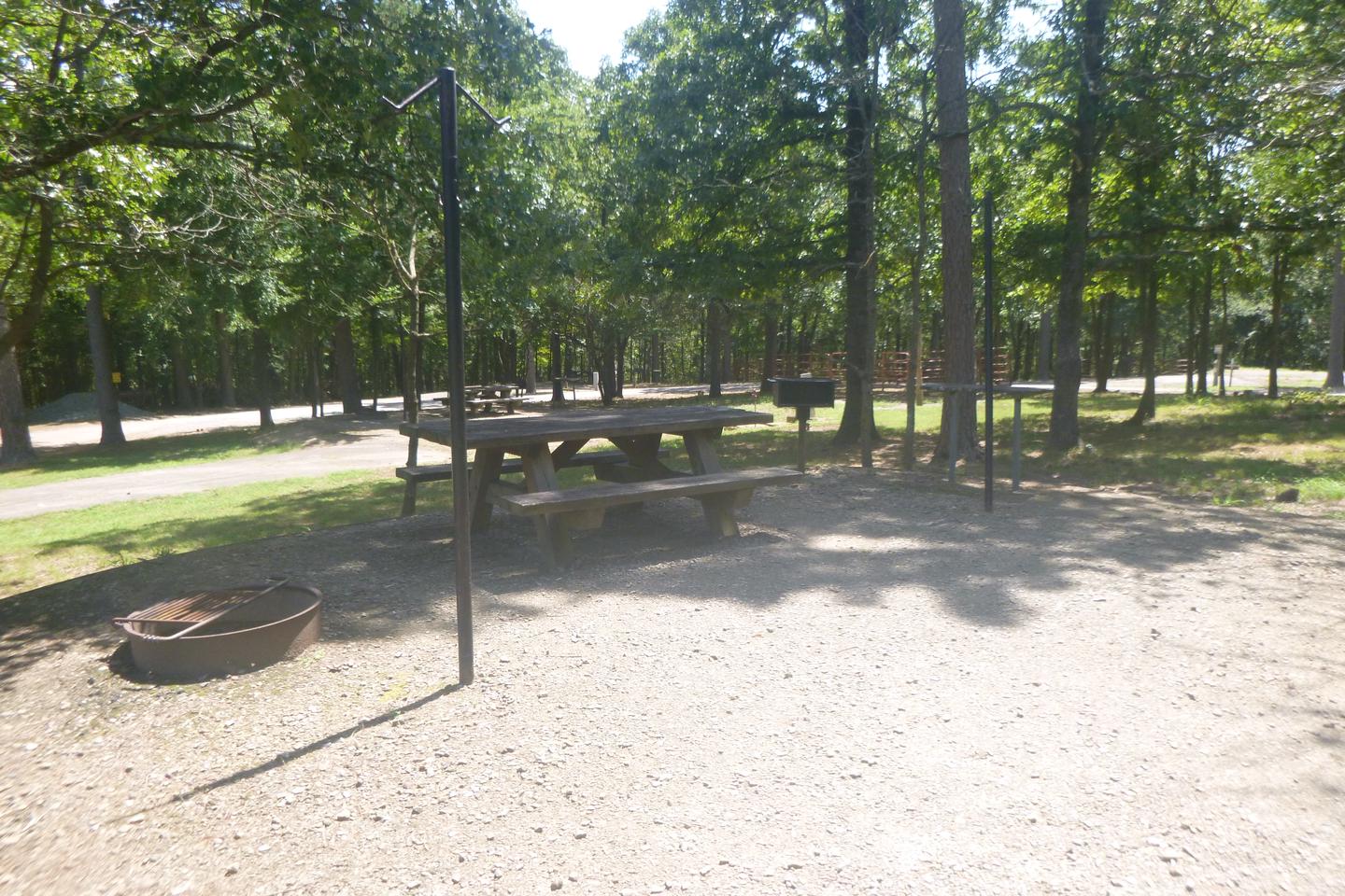 A photo of Site E012 of Loop HCLE at CEDAR LAKE (OKLAHOMA) with picnic table, fire ring, grill, lantern postsSite E12 with picnic table, fire ring, grill, lantern posts