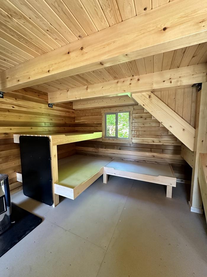 Wood cabin interior with bunksAnan Bay cabin interior bunks on lower level