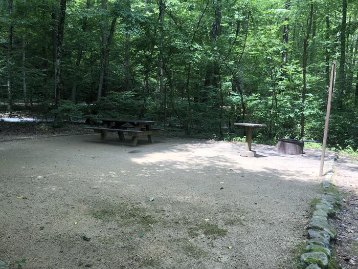 A photo of Site 017 of Loop CAVE MOUNTAIN LAKE FAMILY CAMP at CAVE MOUNTAIN LAKE FAMILY CAMP with Fire Pit, Shade, Tent Pad, Lantern Pole