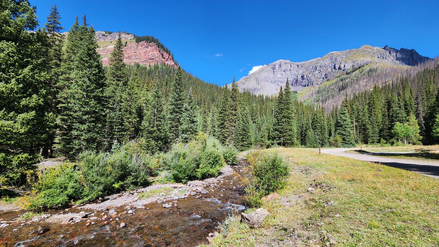 South Mineral Creek running behind campground wiht mountains in the background