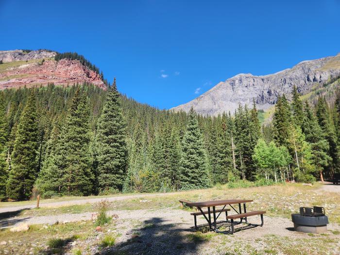 Campsite with picnic table and fire ring with views of the mountain