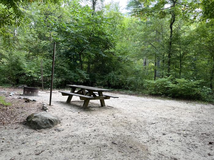 A photo of Site 026 of Loop CAVE MOUNTAIN LAKE FAMILY CAMP at CAVE MOUNTAIN LAKE FAMILY CAMP with Picnic Table, Fire Pit, Lantern Pole