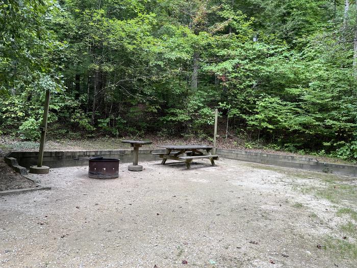 A photo of Site 022 of Loop CAVE MOUNTAIN LAKE FAMILY CAMP at CAVE MOUNTAIN LAKE FAMILY CAMP with Picnic Table, Fire Pit, Lantern Pole