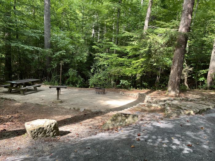 A photo of Site 032 of Loop B at CAVE MOUNTAIN LAKE FAMILY CAMP with Picnic Table, Fire Pit, Shade, Tent Pad, Lantern Pole