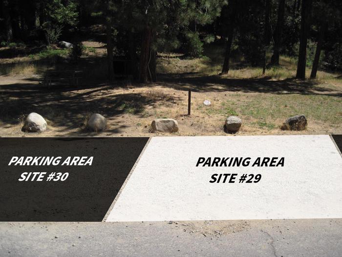 Grassy hillside with parking area at the bottom. Two black boxes (indicating parking for campsites 28 and 30) are overlayed on the image. A white box on the image indicates the parking for campsite 29.Parking pad for site #29. It is shared with sites #28 and #30. Will fit two cars, pulled straight forward.