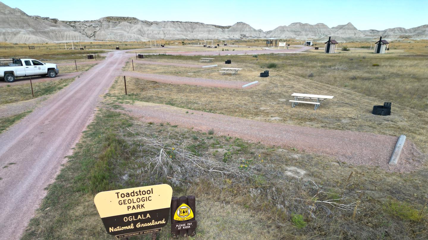 Entrance into the Toadstool Campground with badlands in the background.