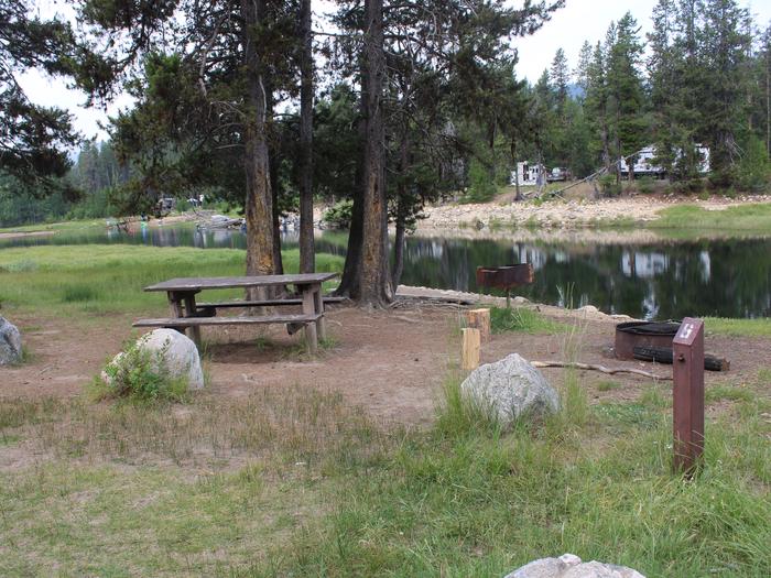 Campsite 6 post, table, fire ring and grill near Deadwood River Campsite 6. River Side campground Boise National Forest