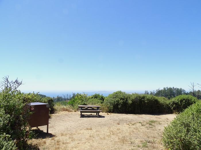 Campsite with picnic table, and food storage locker.Sky 10