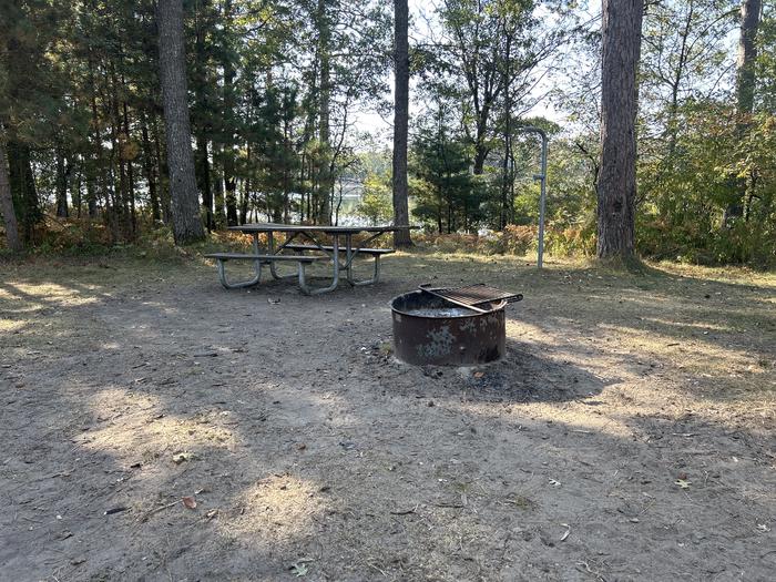 Campfire ring, picnic table, and lantern post in campsite 33