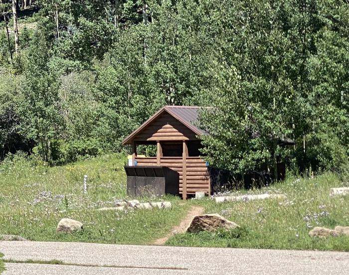 Vault Toilet with bear-proof trash cans