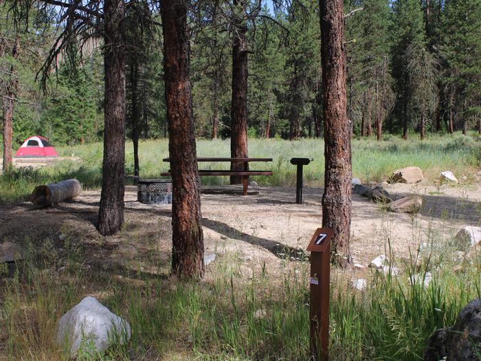 Site 7 post, trees and picnic table are visible in backgroundSite 7, Mountain View Campground. Boise National Forest. 