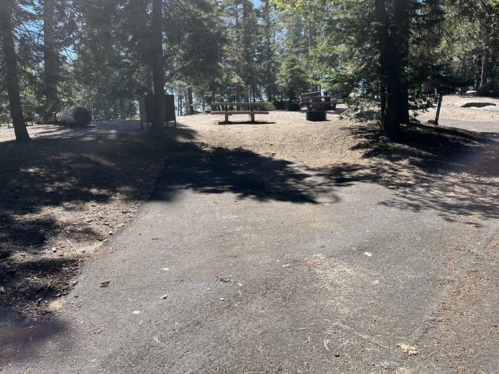 Parking pad showing bear box, fire ring, picnic table, and trees in siteParking pad