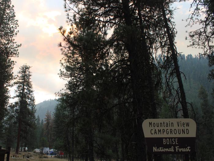 Sunshines down behind trees in the mountain view campgroundMountain View Campground Sign