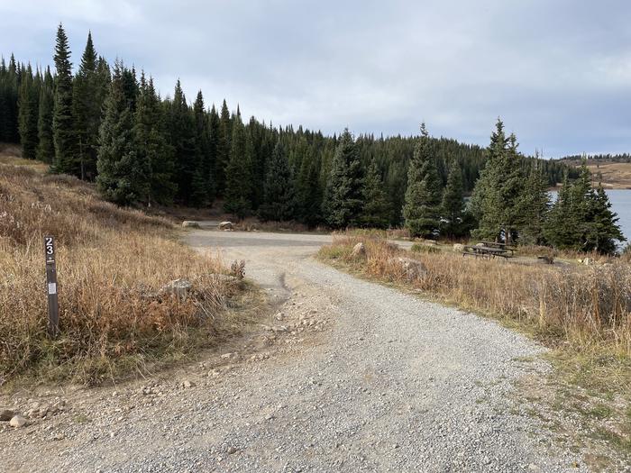 A photo of Site 23 at Deep Lake Campground with Picnic Table, Fire Pit, Shade, Tent Pad