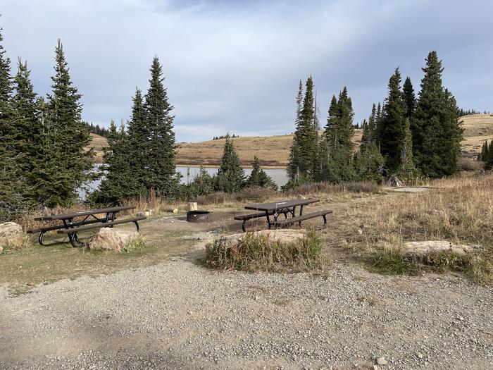 A photo of Site 23 at Deep Lake Campground with Picnic Table, Fire Pit, Shade, Tent Pad, Waterfront