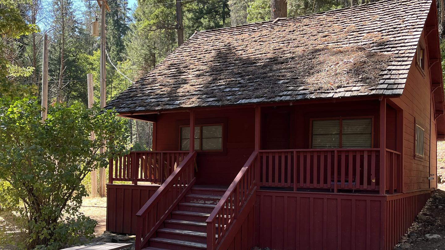 Portion of roof and porch of old, red cabin.Historic Forest Glen Guard Station in the Fall