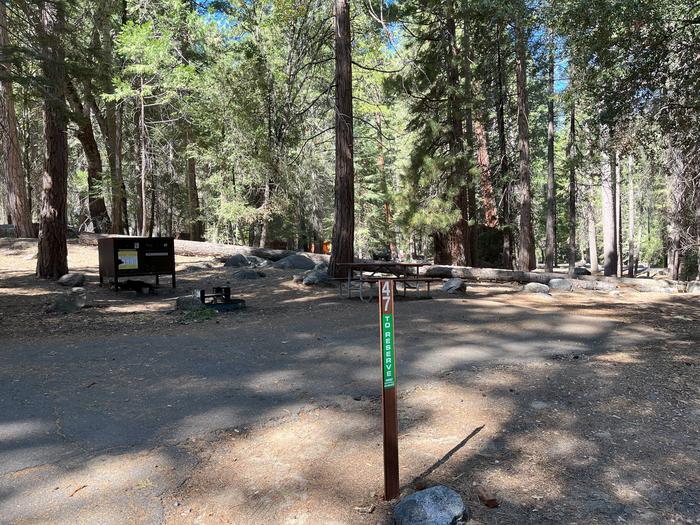 Scene showing full campsite, parking pad and post with the number 47 on itSite #47 Parking Pad
